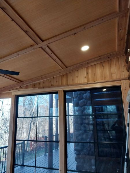 Sliding glass door between a four-season room and the existing log home