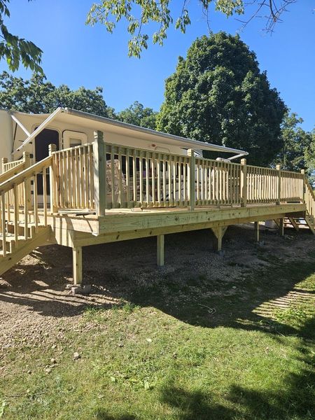 Travel trailer deck railing and stairs in afternoon sun