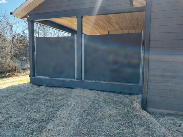 Covered patio with privacy shades extended between the posts
