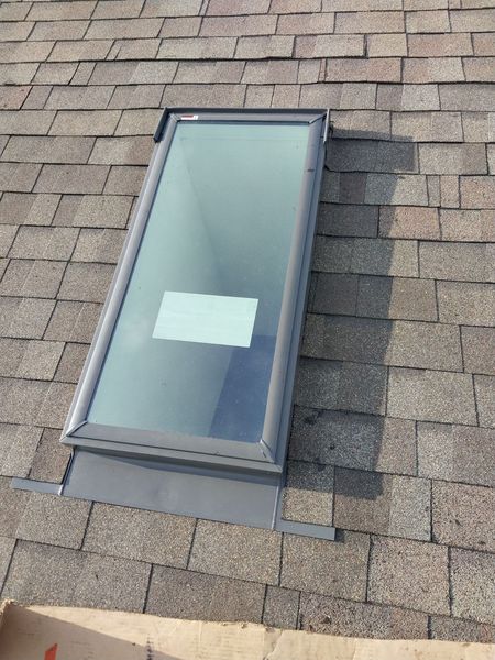 Finished roof skylight flashed into the shingles