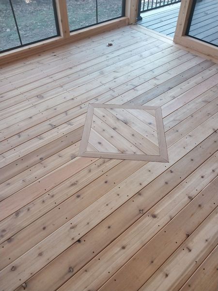 Cedar plank floor with a diamond-pattern inlay