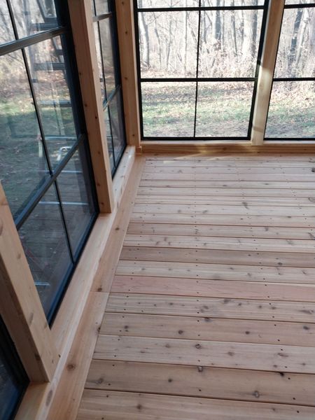 Cedar floor running the length of a glass-walled room