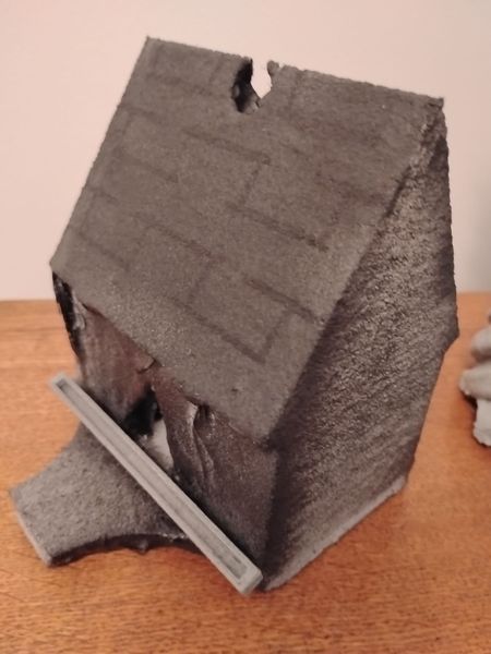 Small decorative house form coated in microcement